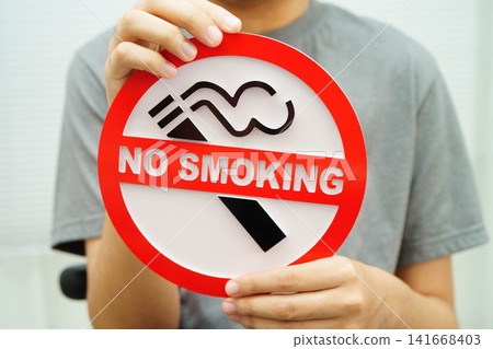 Male holding a no smoking sign. Male holding a no smoking sign. 141668403