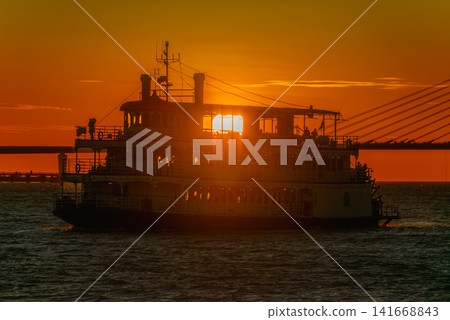 Sunset Silhouette of a Ferry at Tamsui River in New Taipei City Sunset Silhouette of a Ferry at Tamsui River in New Taipei City 141668843