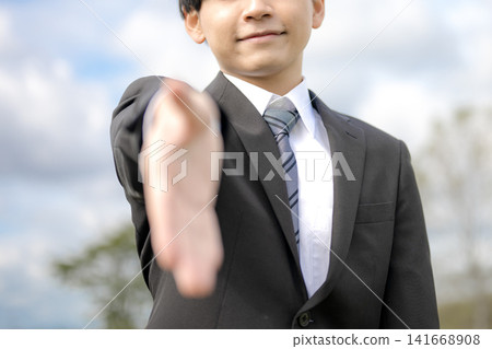 A businessman extending his hand, symbolizing a handshake and trust. A businessman extending his hand, symbolizing a handshake and trust. 141668908