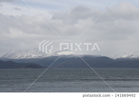 The snow-capped mountains and seascape of Ushuaia The snow-capped mountains and seascape of Ushuaia 141669492