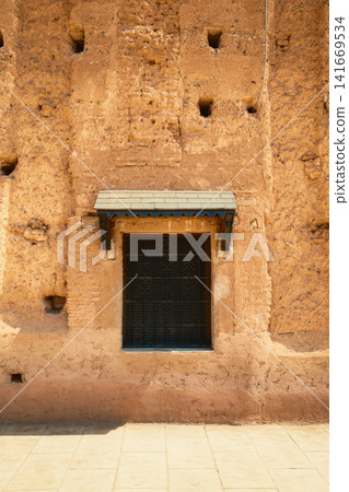 Small window set in ancient earthen wall Small window set in ancient earthen wall 141669534