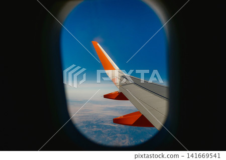 Scenic Sky View from Airplane Window Seat Scenic Sky View from Airplane Window Seat 141669541