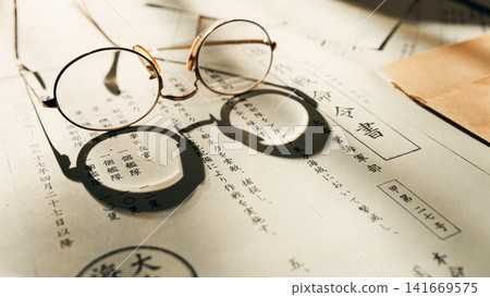 Reading glasses on vintage paper documents Reading glasses on vintage paper documents 141669575
