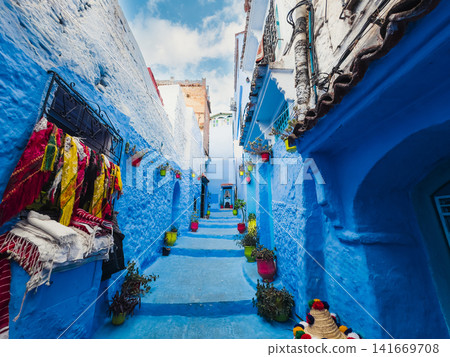 Colorful fabrics hanging in blue alley Colorful fabrics hanging in blue alley 141669708