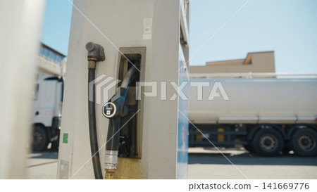 Gasoline pump with tanker truck background Gasoline pump with tanker truck background 141669776