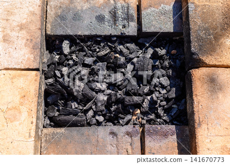 Charcoal in grill tray close up Charcoal in grill tray close up 141670773