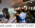 A moment to enjoy gelato at a cafe. 141671145