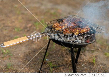 Delicious meat steaks cooking on charcoal grill backdrop Delicious meat steaks cooking on charcoal grill backdrop 141671550