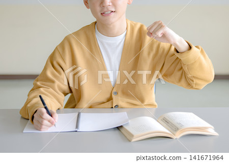 A man making a victory pose; an image associated with studying and self-improvement. A man making a victory pose; an image associated with studying and self-improvement. 141671964