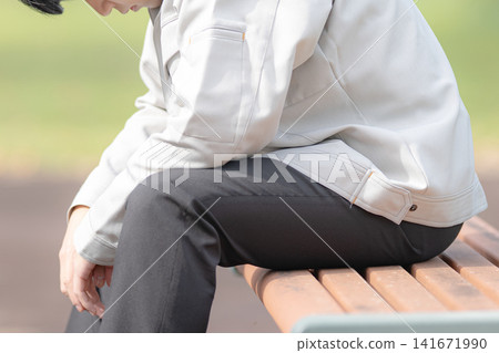 A man in casual clothes sitting on a bench, conveying an image of relaxation and everyday life. A man in casual clothes sitting on a bench, conveying an image of relaxation and everyday life. 141671990