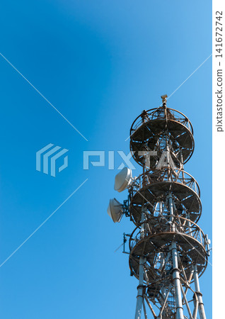[Blue Sky and Communication Tower] A landscape with a radio tower and antenna equipment; background material with copy space. 141672742