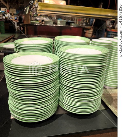 Stacks of green ceramic plates on the serving line in a restaurant. Stacks of green ceramic plates on the serving line in a restaurant. 141672850