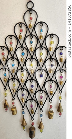 Wall-hanging decoration with brass bells and colorful beads Wall-hanging decoration with brass bells and colorful beads 141672856