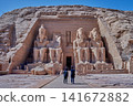Abu Simbel, Aswan, Egypt- February 10 2025: Abu Simbel Temples in Abu Simbel Aswan, Egypt exterior daylight shot showing The Great Temple of Ramesses II with tourist at the main entrance Abu Simbel, Aswan, Egypt- February 10 2025: Abu Simbel Temples in Abu Simbel Aswan, Egypt exterior daylight shot showing The Great Temple of Ramesses II with tourist at the main entrance 141672882