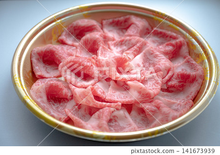 Assortment of thinly sliced beef, for sukiyaki. Assortment of thinly sliced beef, for sukiyaki. 141673939