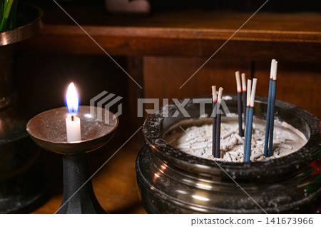 Candles and incense on a Buddhist altar, an image of a memorial service. Candles and incense on a Buddhist altar, an image of a memorial service. 141673966