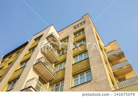 Building facade with balconies against clear blue sky Building facade with balconies against clear blue sky 141675079