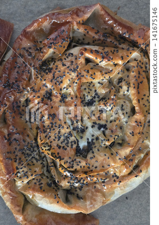 Rustic Homemade Borek with Flaky Layers and Black Sesame Seeds for Culinary Delight Rustic Homemade Borek with Flaky Layers and Black Sesame Seeds for Culinary Delight 141675146