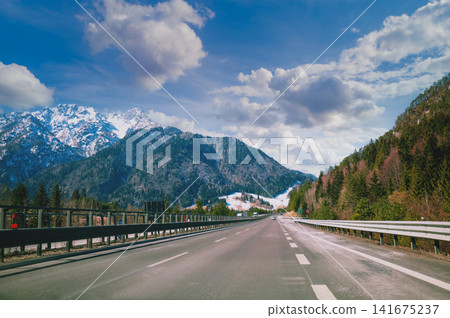 Driving a car on the autobahn between the mountains in Slovenia Driving a car on the autobahn between the mountains in Slovenia 141675237