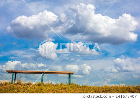 A bench against a beautiful sky. View from below A bench against a beautiful sky. View from below 141675407