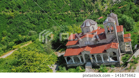 Aerial view of abandoned leaning stone church of Agia Paraskevi tilted by landslide disaster in deserted ghost village Ropoto Trikala Thessaly Greece stock photo Aerial view of abandoned leaning stone church of Agia Paraskevi tilted by landslide disaster in deserted ghost village Ropoto Trikala Thessaly Greece stock photo 141675662