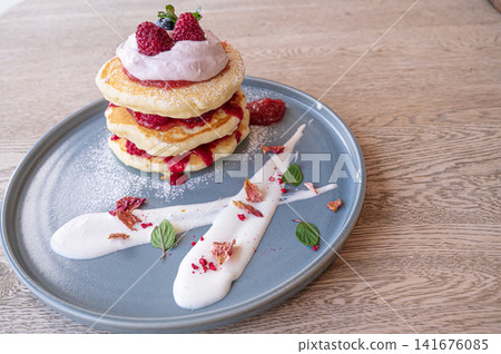 A plate of pancakes and cream art, a dessert plate. A plate of pancakes and cream art, a dessert plate. 141676085