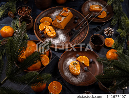 Holiday dessert roll with tangerines and festive decor Holiday dessert roll with tangerines and festive decor 141677407