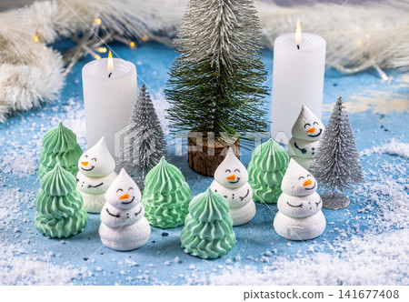 Meringue snowmen and christmas trees creating winter wonderland Meringue snowmen and christmas trees creating winter wonderland 141677408