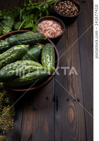 Fresh cucumbers and pickling ingredients on rustic wooden table Fresh cucumbers and pickling ingredients on rustic wooden table 141677418