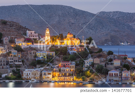 Illuminated Orthodox Church Above Symi Harbor at Blue Hour on Symi Island Greece 141677701