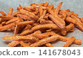 Frozen Sweet Potato Fries Close Up with Crispy Orange Texture 141678043