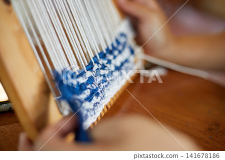 Weaving on a loom frame Weaving on a loom frame 141678186