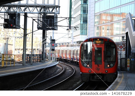 A London Underground train departing from Paddington Station in London, England. A London Underground train departing from Paddington Station in London, England. 141678229