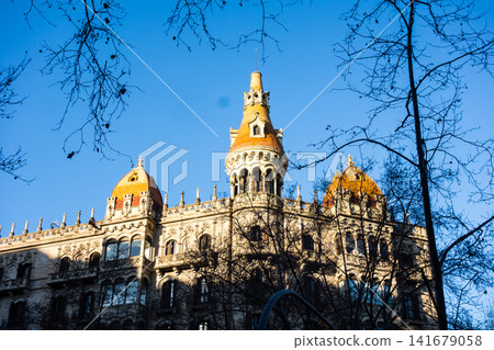 Historic brick and stone buildings bathed in the morning sun under a clear blue sky: the streets of Barcelona, Spain. Historic brick and stone buildings bathed in the morning sun under a clear blue sky: the streets of Barcelona, Spain. 141679058