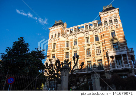 Historic brick and stone buildings bathed in the morning sun under a clear blue sky: the streets of Barcelona, Spain. Historic brick and stone buildings bathed in the morning sun under a clear blue sky: the streets of Barcelona, Spain. 141679071