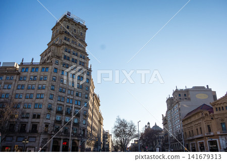 Historic brick and stone buildings bathed in the morning sun under a clear blue sky: the streets of Barcelona, Spain. Historic brick and stone buildings bathed in the morning sun under a clear blue sky: the streets of Barcelona, Spain. 141679313