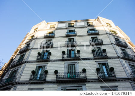 Historic brick and stone buildings bathed in the morning sun under a clear blue sky: the streets of Barcelona, Spain. Historic brick and stone buildings bathed in the morning sun under a clear blue sky: the streets of Barcelona, Spain. 141679314