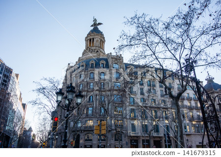 Historic brick and stone buildings bathed in the morning sun under a clear blue sky: the streets of Barcelona, Spain. Historic brick and stone buildings bathed in the morning sun under a clear blue sky: the streets of Barcelona, Spain. 141679315