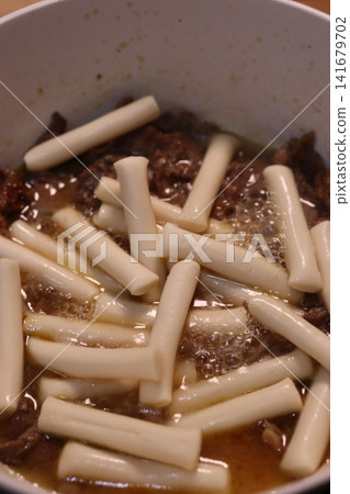 Cooking Rice Cakes with Meat in Sauce 141679702