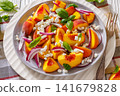 Fresh peach salad with goat cheese on a plate 141679828