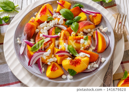 Fresh peach salad with goat cheese on a plate Fresh peach salad with goat cheese on a plate 141679828