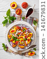 Italian peach salad with cheese, basil leaves 141679831