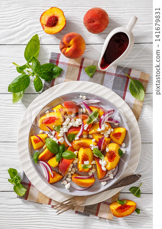 Italian peach salad with cheese, basil leaves Italian peach salad with cheese, basil leaves 141679831