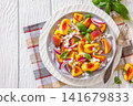 Fresh peach salad with goat cheese on a plate 141679833