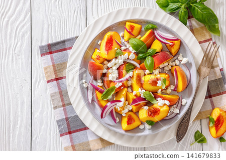 Fresh peach salad with goat cheese on a plate 141679833