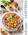 Fresh peach salad with goat cheese on a plate 141679834
