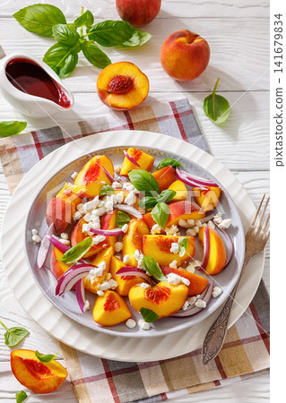 Fresh peach salad with goat cheese on a plate Fresh peach salad with goat cheese on a plate 141679834
