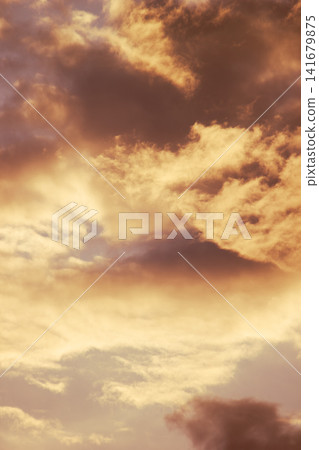 Dramatic cloudy sunset sky with warm golden light background texture Dramatic cloudy sunset sky with warm golden light background texture 141679875