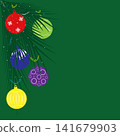 On a green background, there are Christmas tree branches and colorful Christmas tree balls. 141679903