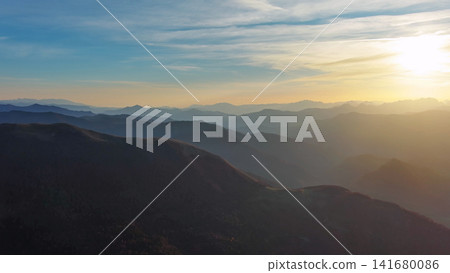 Flying over colorful foliage at sunset in mountains Flying over colorful foliage at sunset in mountains 141680086